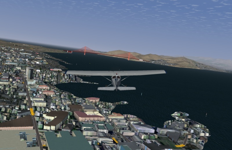 A screenshot from the FlightGear flight simulator, showing a chase-plane view of a Cessna 172 over San Francisco.
